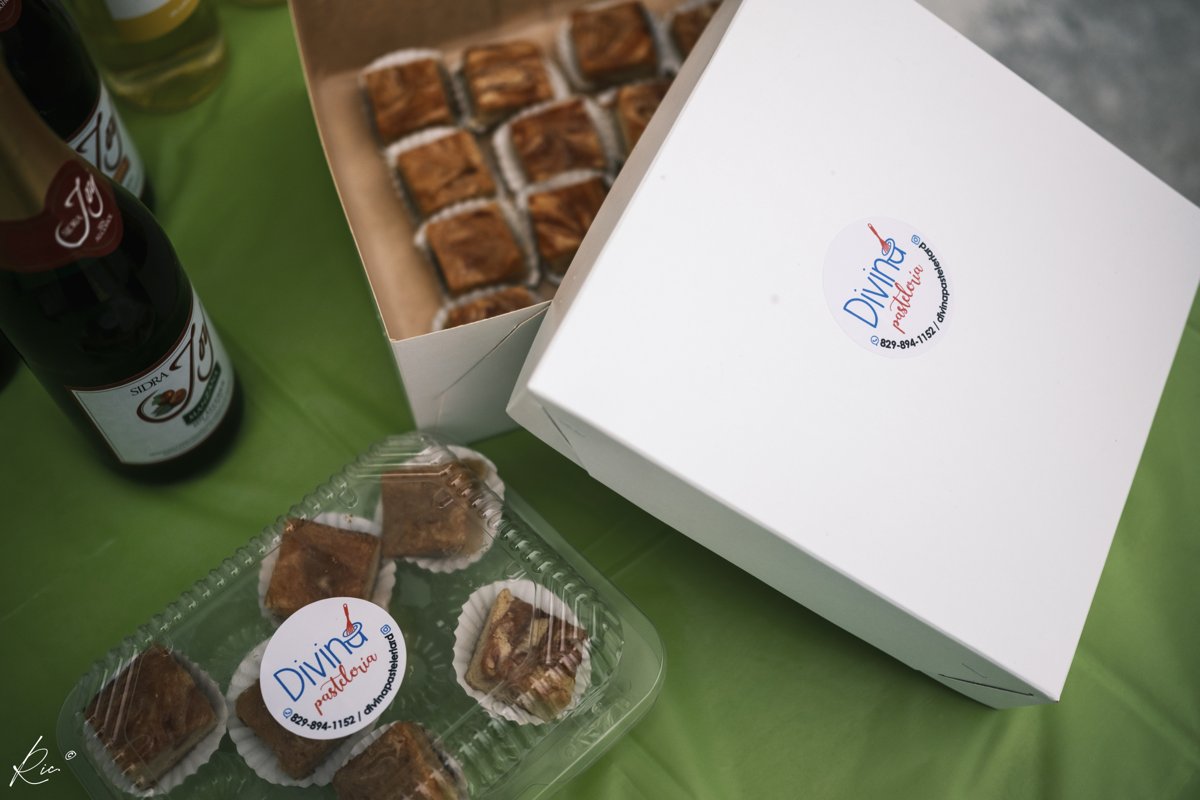 Pastries, a presentation box, and a bottle share the refreshments table.