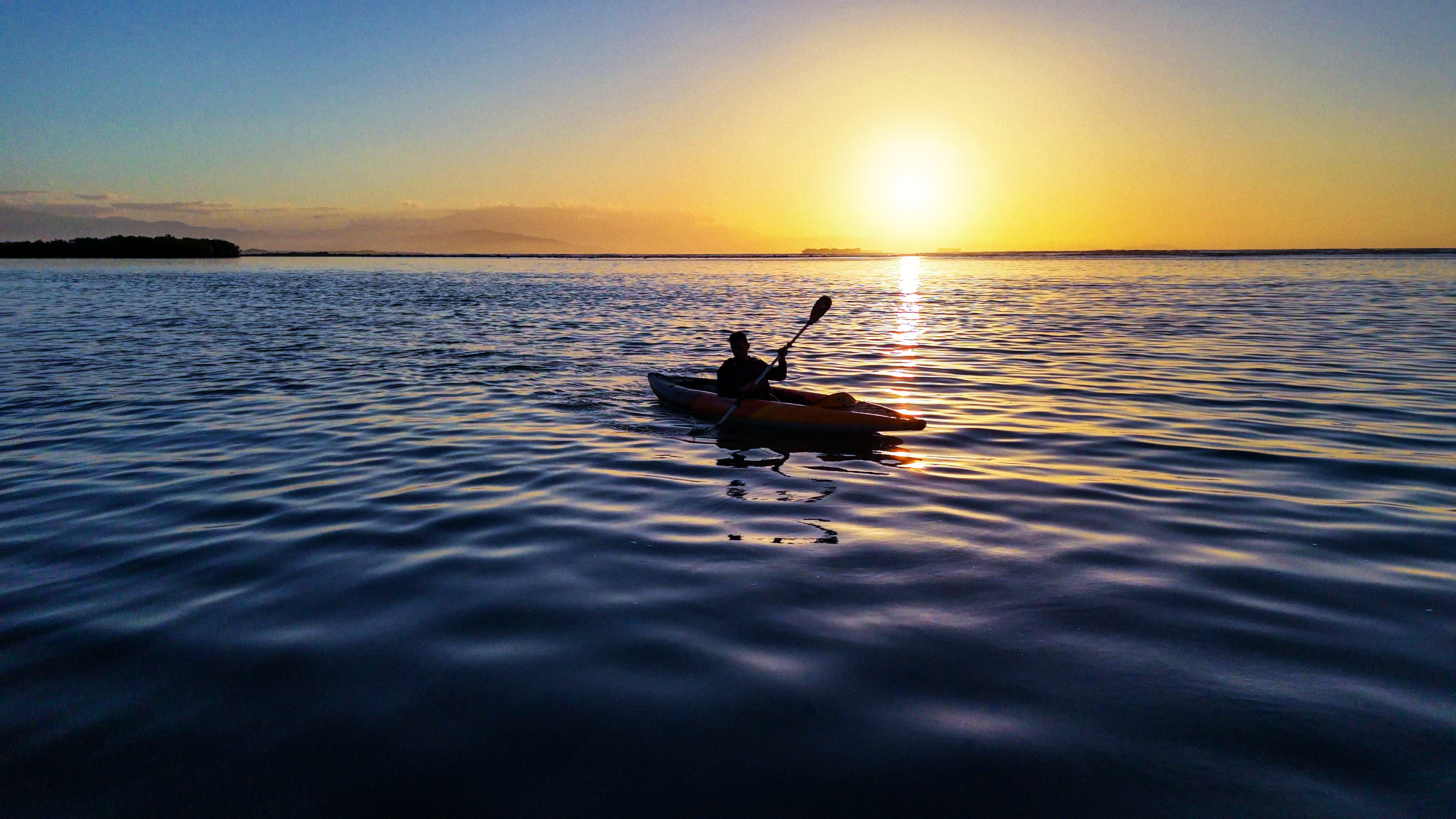 Kayaking across sunlit water at Playa Caobita