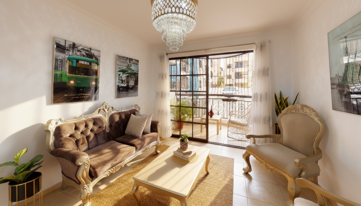 Sunlight crosses a sitting room furnished with tufted seating and a chandelier.