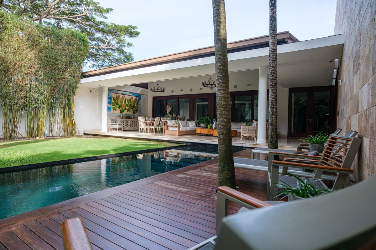 A timber deck connects the pool to the open living terrace.