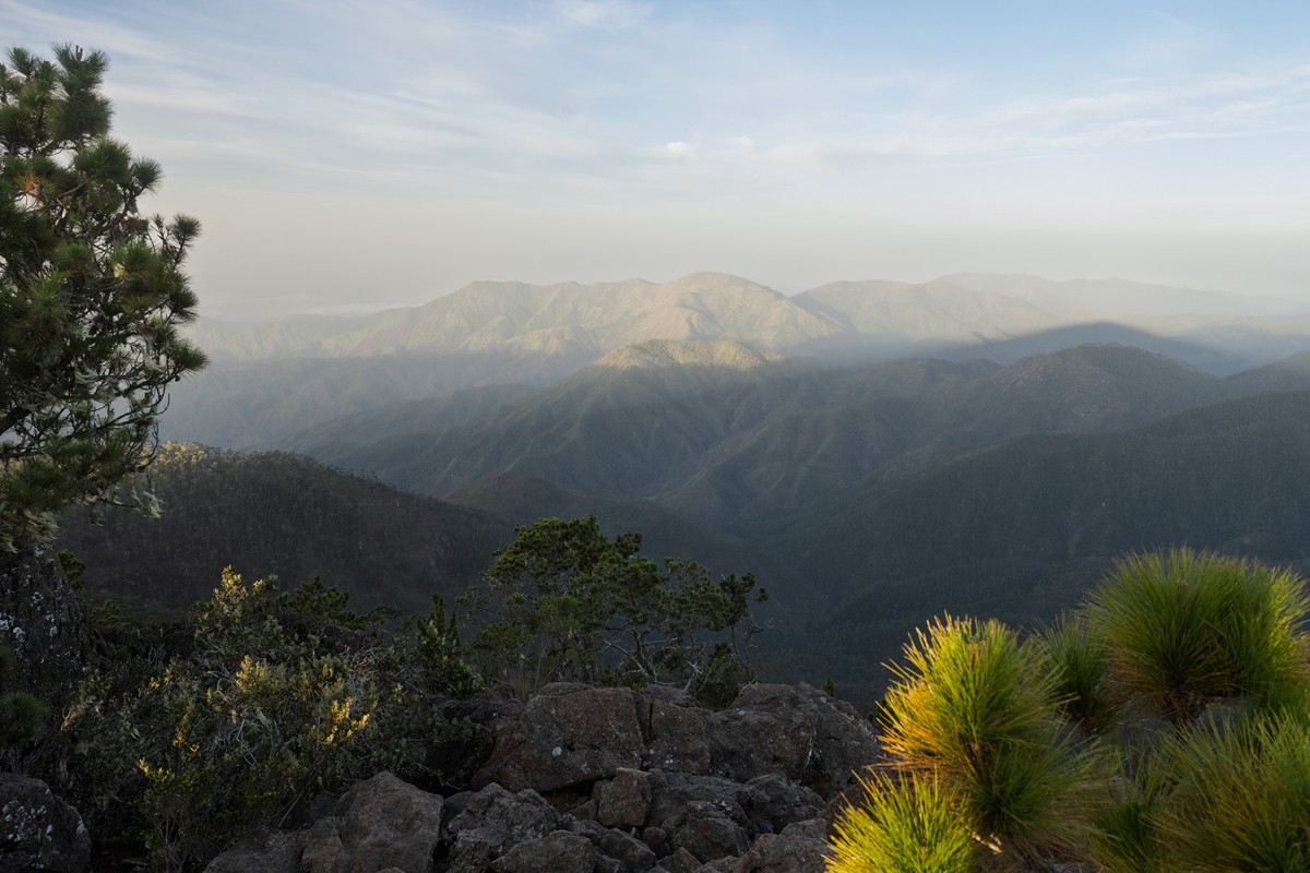 Soft light separates successive layers of mountain.
