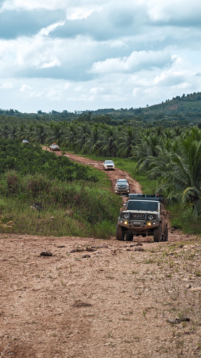 A vehicle approaches along an uneven dirt track.