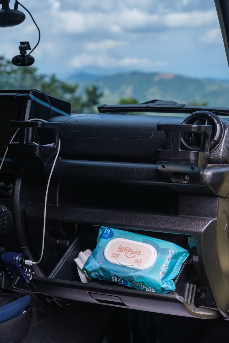 A wipes pack occupies the passenger-side storage inside a vehicle.